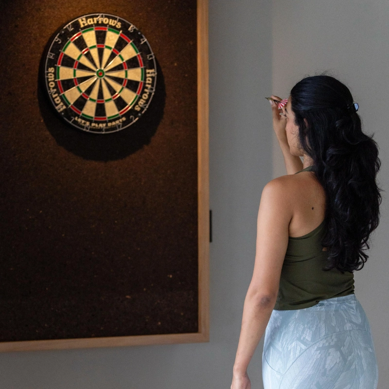 young woman play darts to Izakithi River Villa